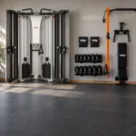 Fold-away cable trainer and wall-mounted folding rack in a home gym with open floor space